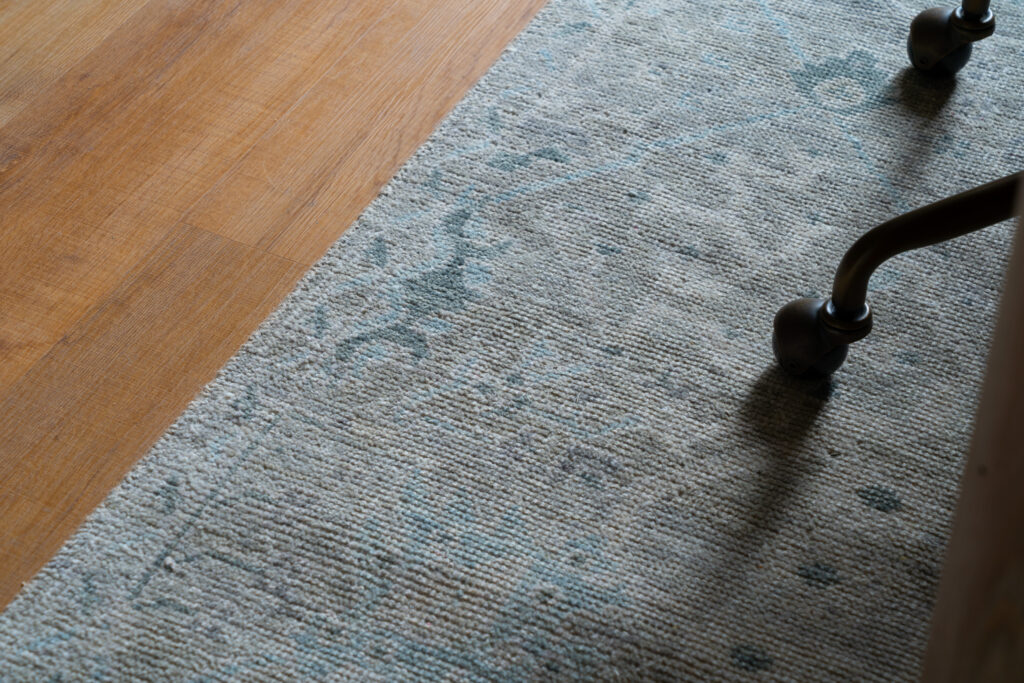 Detail of Jaipur rug layered over hardwood flooring in the studio